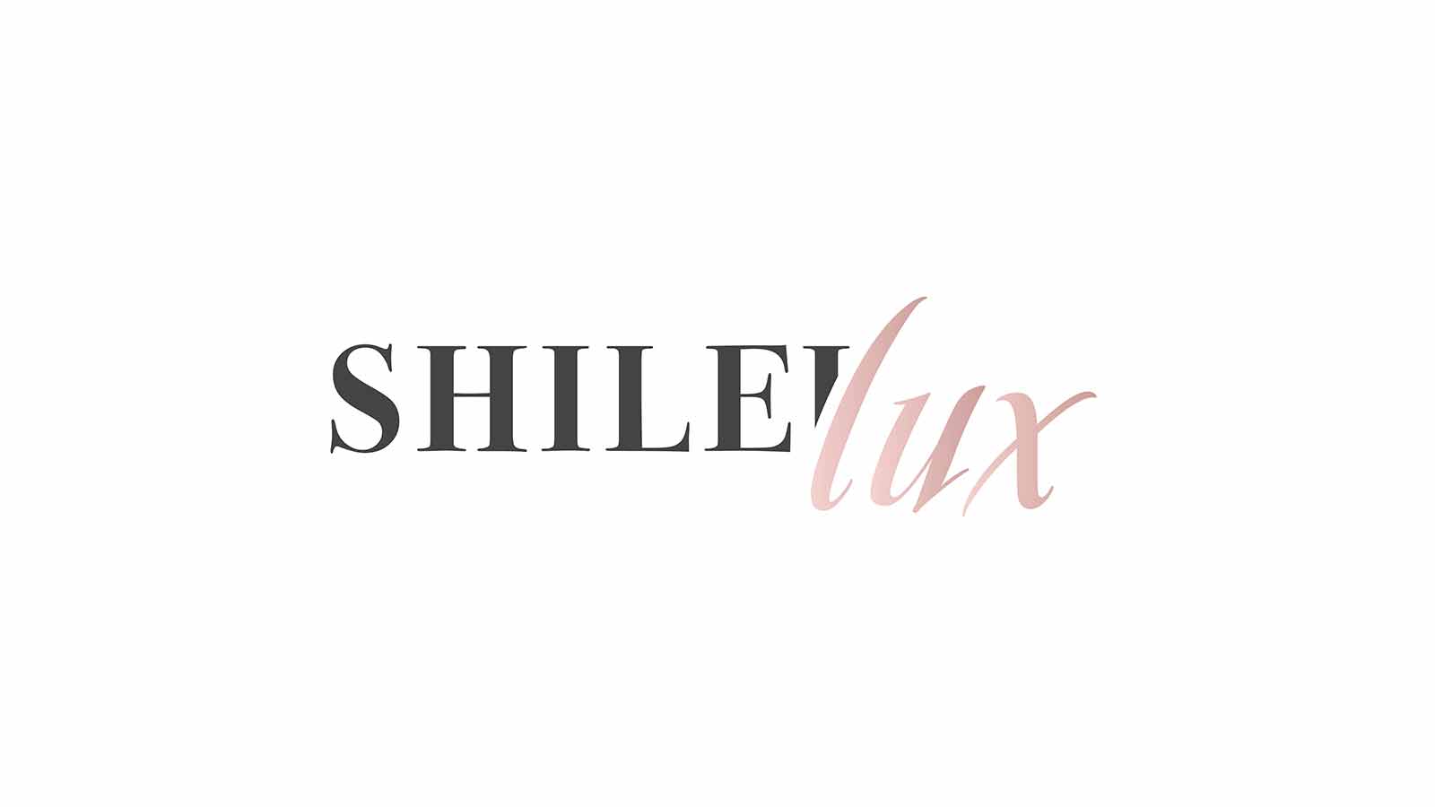 Elegant and minimalist logo for "SHILElux" featuring bold black serif and soft pink script typography, designed by InloDesign – a creative logo design agency in London.