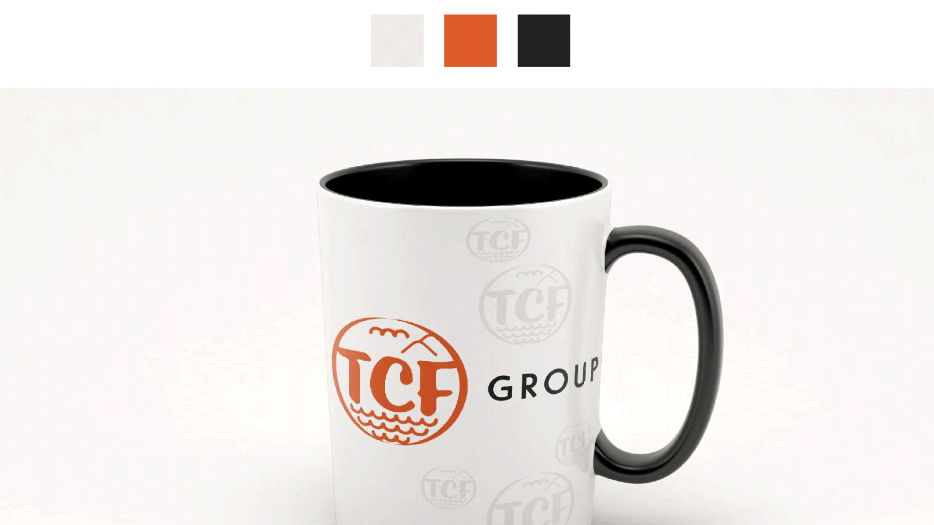 White ceramic mug with black interior and handle, featuring the TCF Group logo in orange and black.